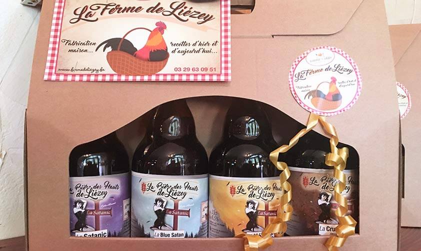 Coffret en carton de la Ferme de Liézey avec 4 bières Satanic différentes