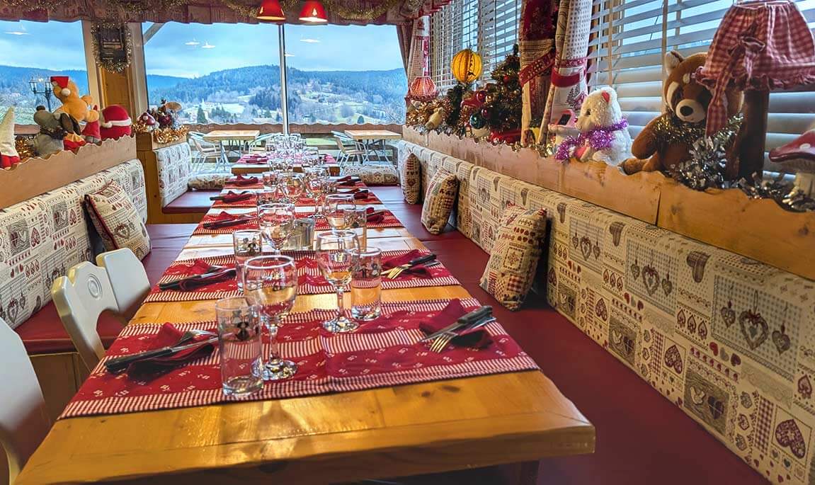 Grande table de restaurant, ambiance chaleureuse et cosy, décoré pour Noël